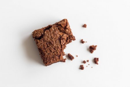 Brownie-half-eaten-white-background-bite-chocolate-treats.jpg
